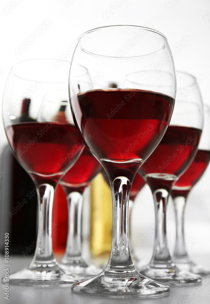 Glasses of red wine on white table closeup Glasses of red wine on white table closeup