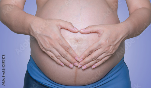 Wallpaper Mural Pregnant woman with hands isolate on white background Torontodigital.ca