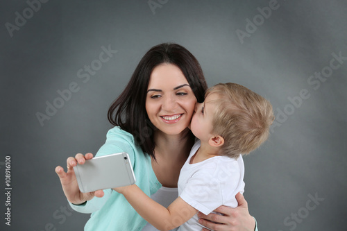 Smiling mom making selfie w...