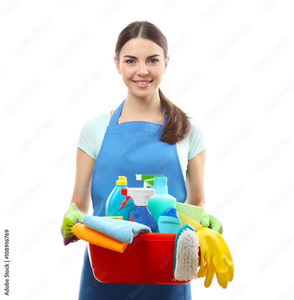 Young woman holding cleaning tools and products in tub, isolated on white Young woman holding cleaning tools and products in tub, isolated on white