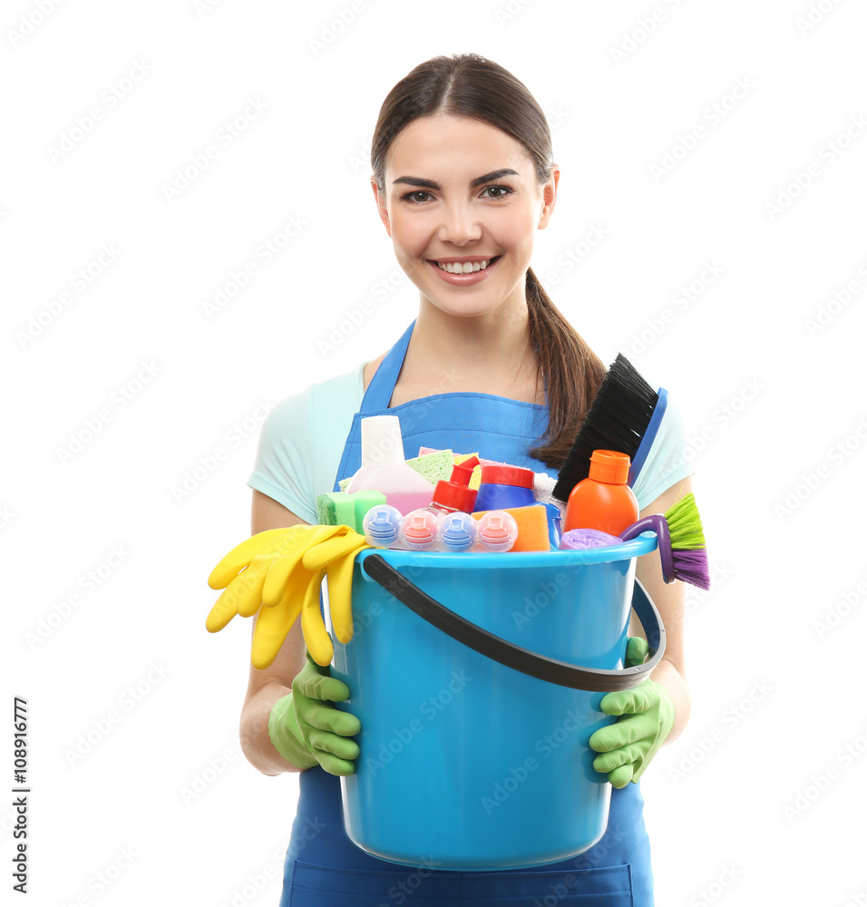 Young woman holding cleaning tools and products in bucket, isolated on white Young woman holding cleaning tools and products in bucket, isolated on white