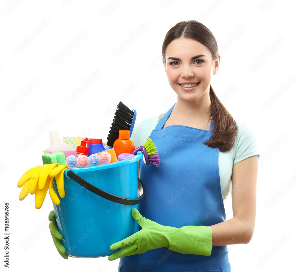 Young woman holding cleaning tools and products in bucket, isolated on white Young woman holding cleaning tools and products in bucket, isolated on white