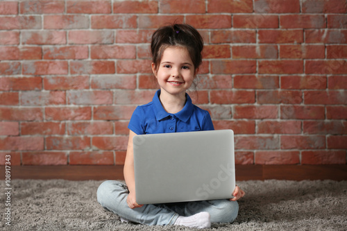 Little girl with laptop on ...