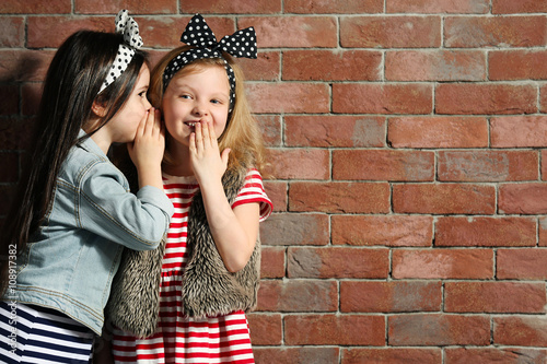 Two stylish little girls on...