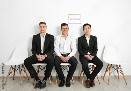 Three men waiting for inter...