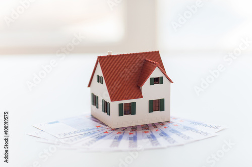 close up of home or house model and money