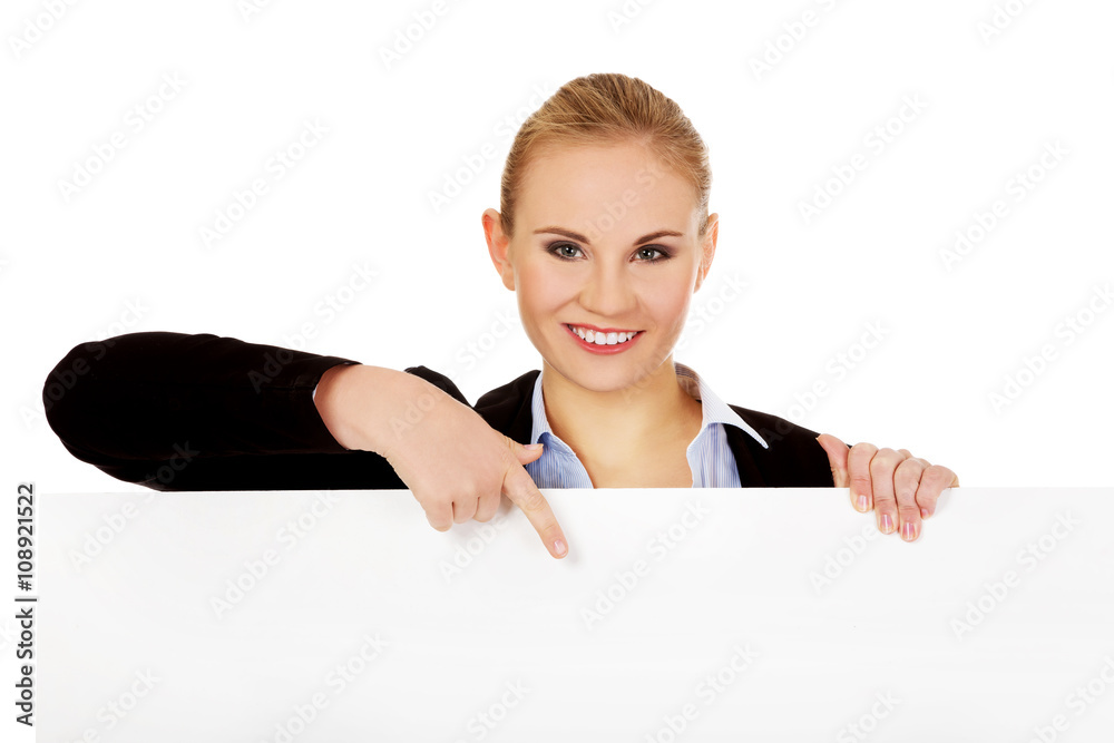 Smiling young businesswoman holding blank banner Smiling young businesswoman holding blank banner