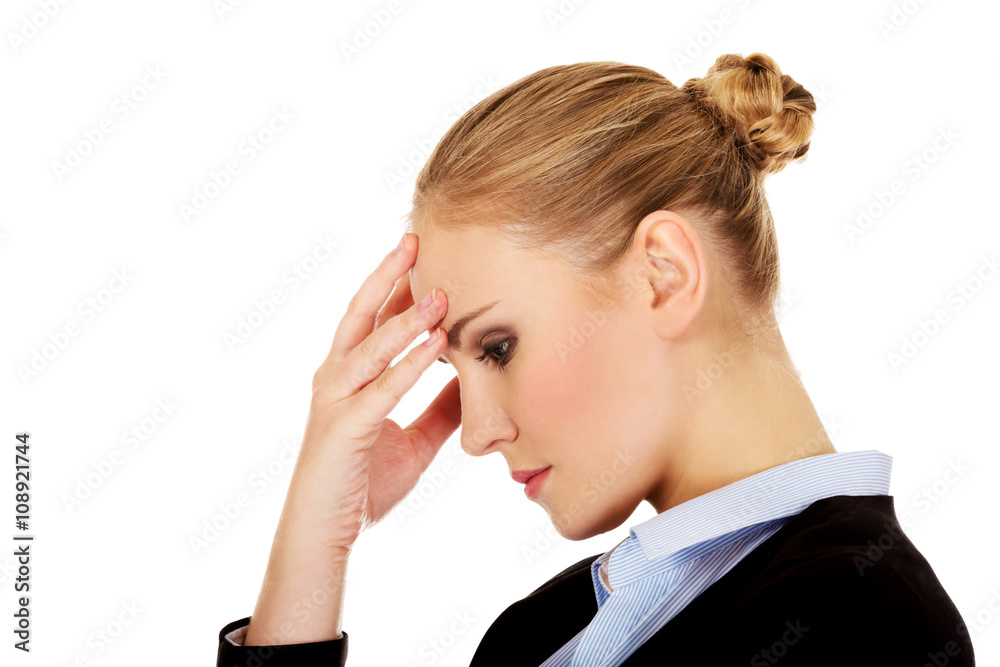 Business woman with a huge headache holding head Business woman with a huge headache holding head