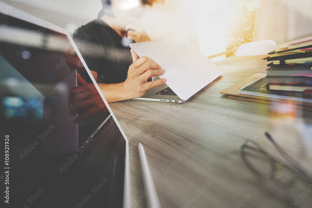 Obraz premium designer hand working with digital tablet and laptop computer an
