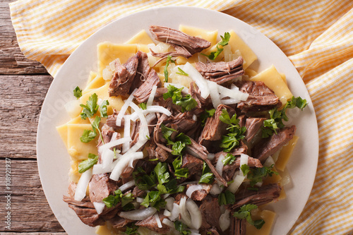 Asian beshbarmak - noodles with lamb and onion close-up. horizontal top view
 photo