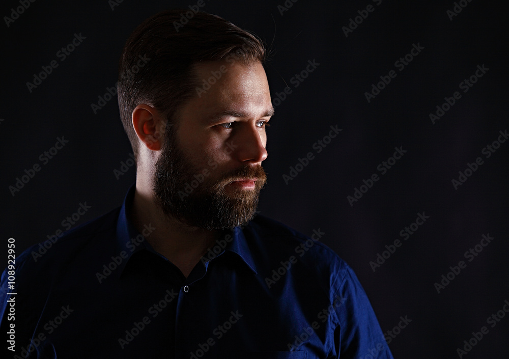 Fototapeta premium Cool businessman standing on dark gradient background