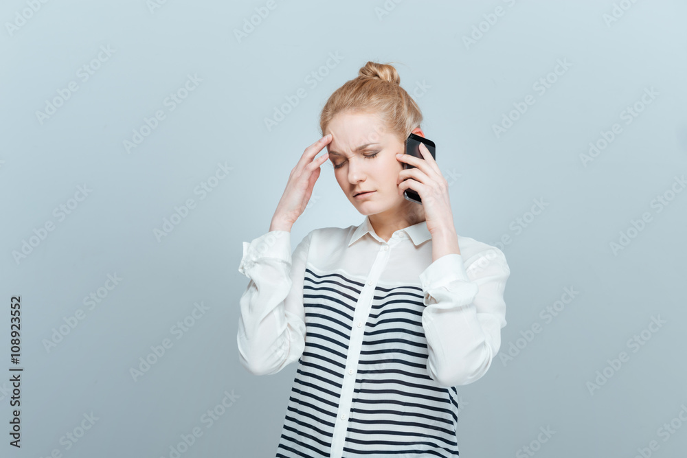 Pensive woman talking on the phone Pensive woman talking on the phone
