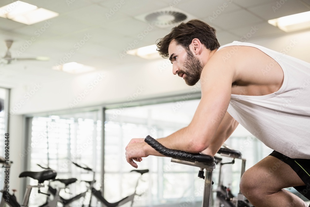 Fit man using exercise bike Fit man using exercise bike