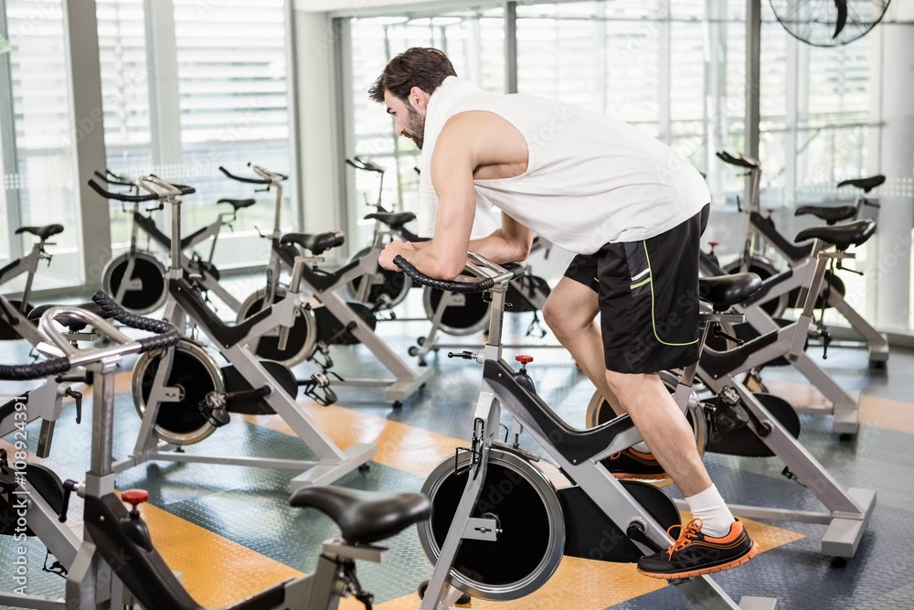 Fit man using exercise bike Fit man using exercise bike