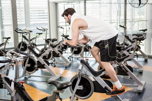 Fit man using exercise bike