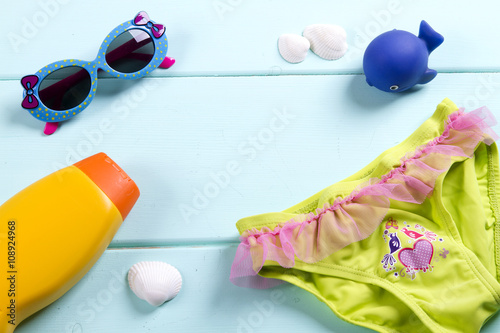 for sea accessories - sunglasses, sun lotion, a toy whale swimsuit. child. kid. sea tour