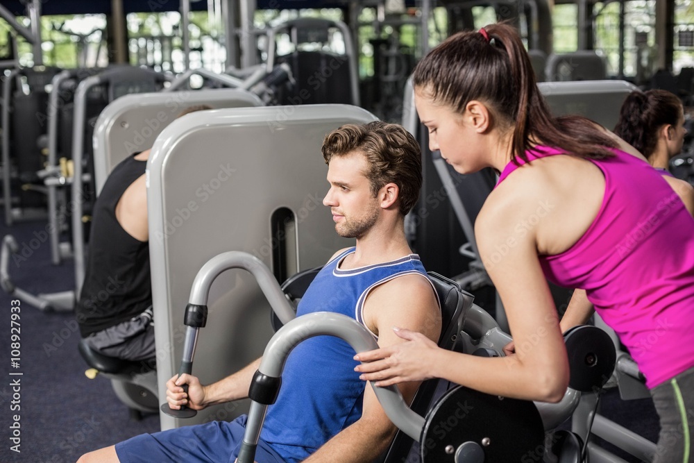 Fototapeta premium Trainer woman helping athletic man