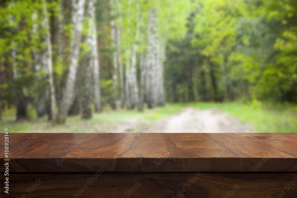 Empty top wooden table and floral blurred background Empty top wooden table and floral blurred background