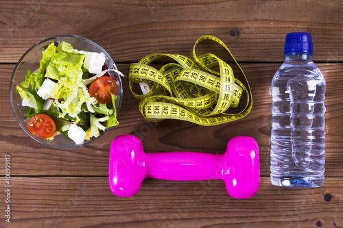diet: salad, tape measure and dumbbells