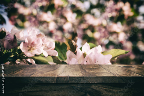Empty top wooden table and floral blurred background