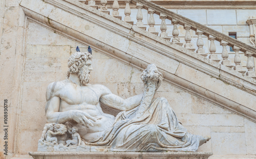 Statue of god(Tiber) with cornucopia at square Piazza del Campidoglio.Part of the sculpture composition of the Fountain of Goddess Rome.Work by Matteo di Castello.Capitol hill.Rome.Italy.Europe