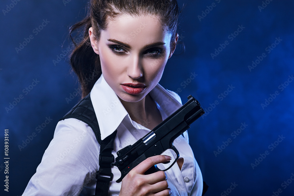 beautiful sexy girl holding gun . smoke background beautiful sexy girl holding gun . smoke background