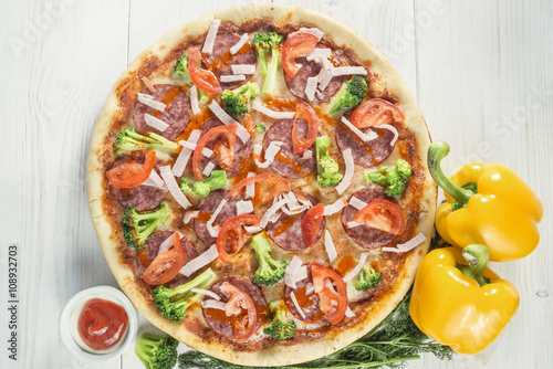 tasty Pizza on wooden table background. Top view with copy space