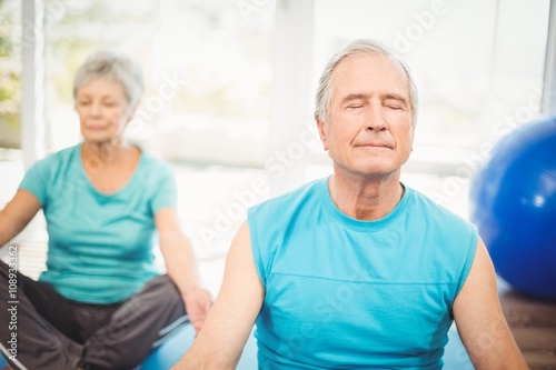 Couple meditating at home