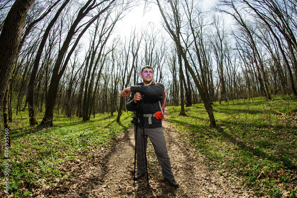 Male hiker looking to the side walking in forest Male hiker looking to the side walking in forest