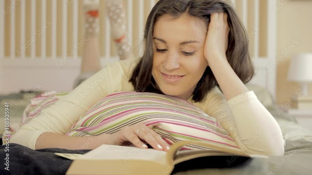 Close up of a girl reading book in bed Close up of a girl reading book in bed