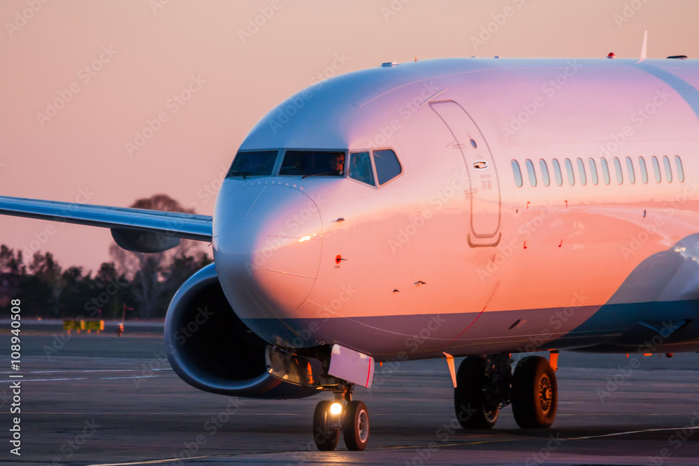 Taxiing aircraft in the morning crimson Taxiing aircraft in the morning crimson