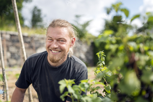 Smiling man working in garden photo