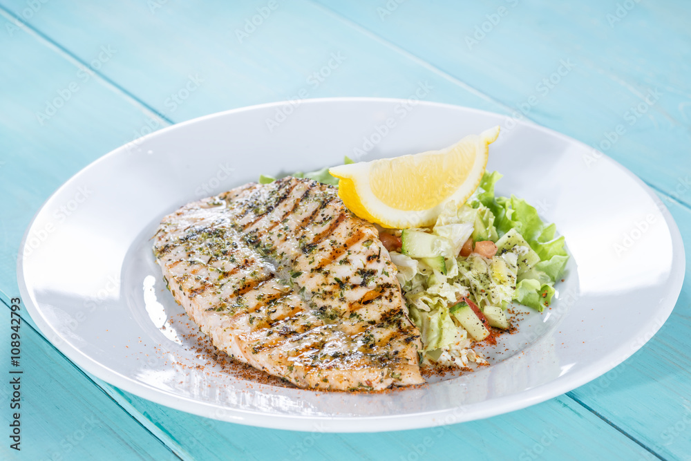 salmon fillet on the grill serve fresh salad and lemon salmon fillet on the grill serve fresh salad and lemon