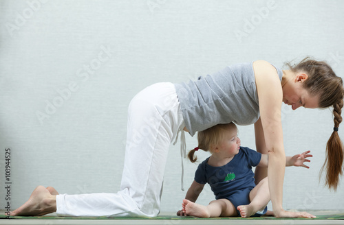 yoga baby mom. Mom exercise workout with a child 1.5 years.