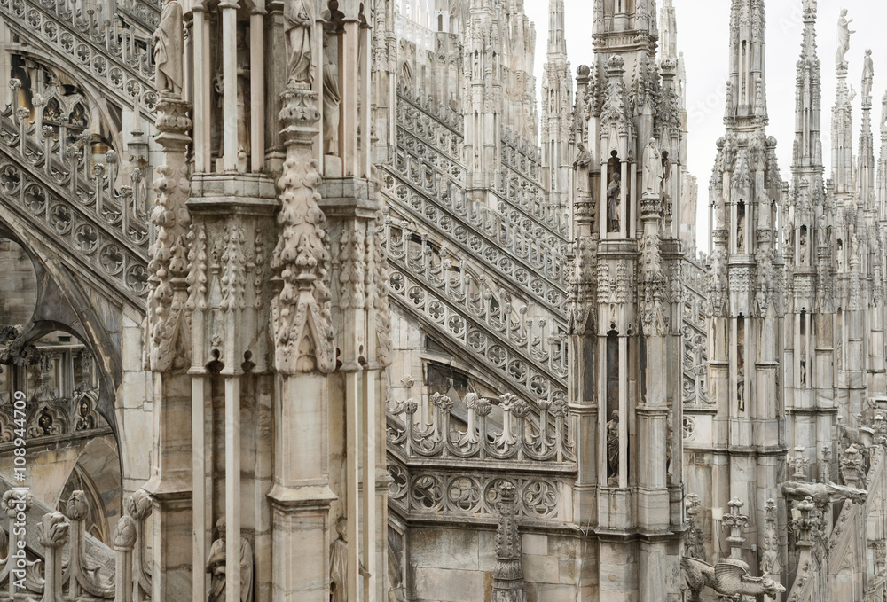 Milan cathedral roof gothic ornaments spire pointed arches statues marble