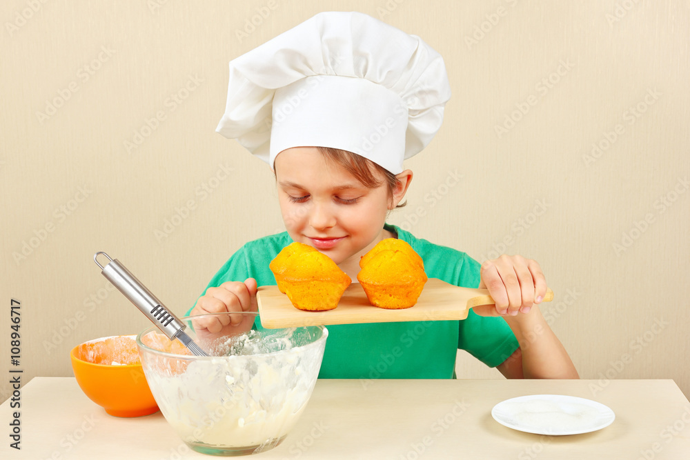 Little funny chef sniffing the aroma of cooked cake Little funny chef sniffing the aroma of cooked cake