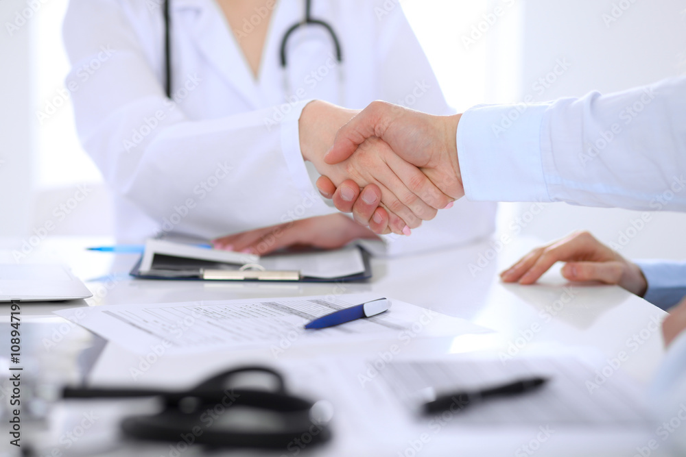 Doctor and patient handshaking. Hands close-up Doctor and patient handshaking. Hands close-up