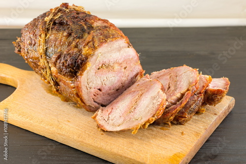 Roasted rolled pork meat on a cutting board