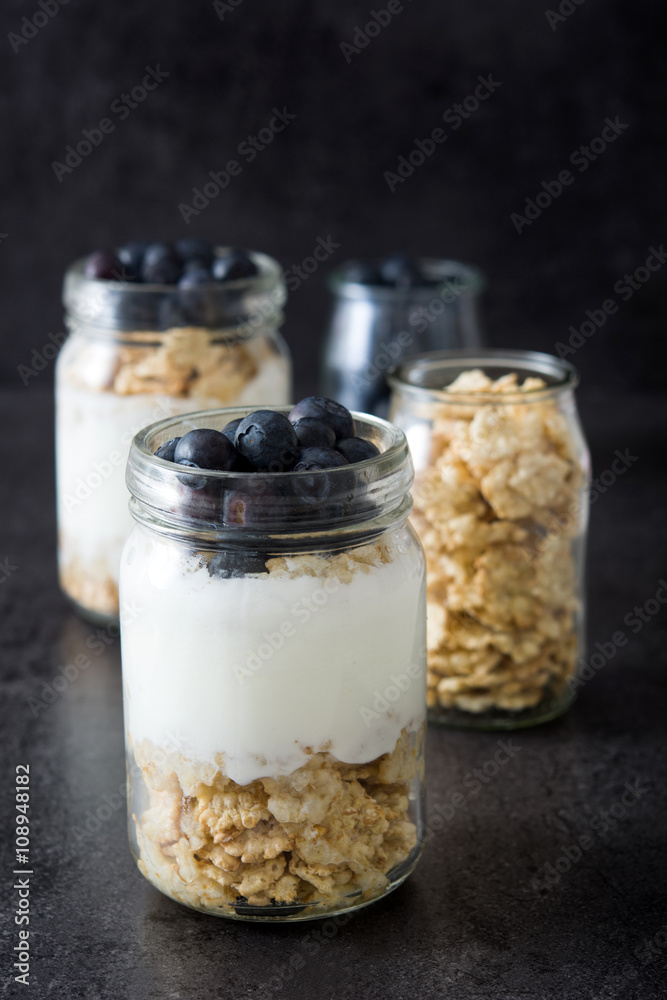 Yogurt with blueberries on black background
Yogurt with blueberries on black background