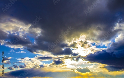 Colorful sunrise, sunset clouds and sun rays