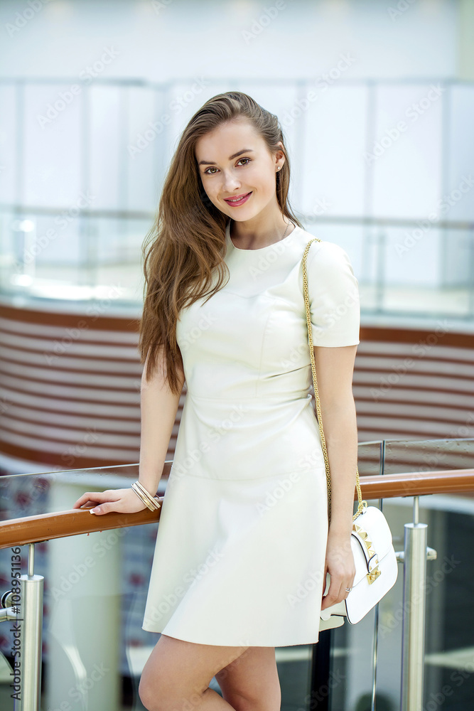 Beautiful young woman walks in the shop Beautiful young woman walks in the shop