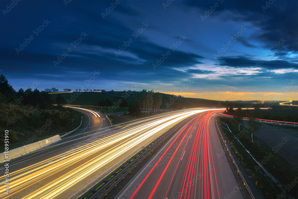 Long-exposure sunset over a highway