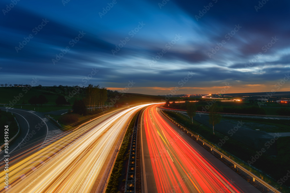 Long-exposure sunset over a highway Long-exposure sunset over a highway