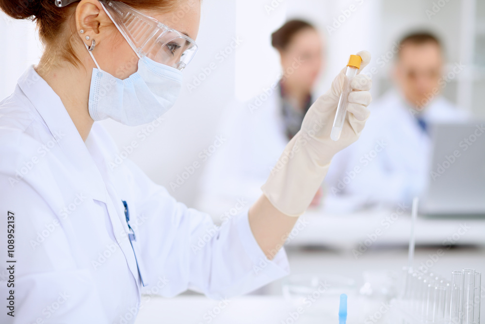 Scientific research team with clear solution in laboratory Scientific research team with clear solution in laboratory
