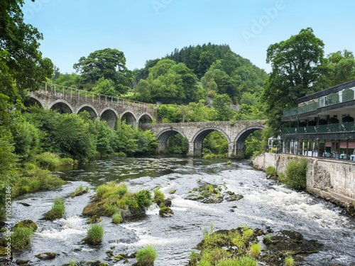 River Dee with road and railway bridges in Llangollen Denbighshire Wales UK photo