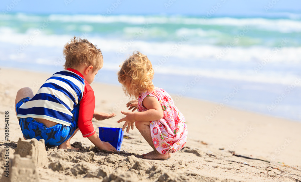 kids play with sand on summer beach kids play with sand on summer beach