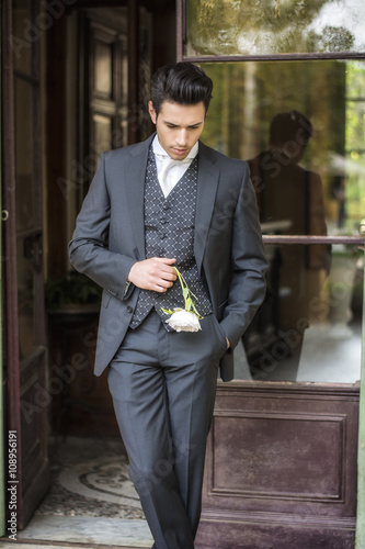 Handsome bridegroom in grey suit