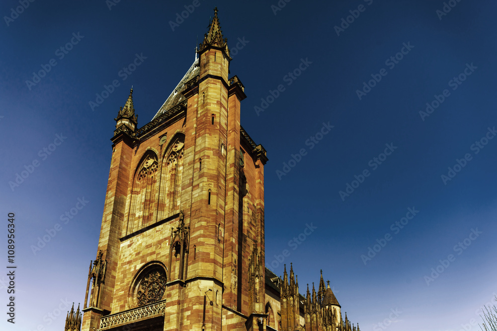 Fototapeta premium Majestic gothic cathedral in little city Niederhaslach