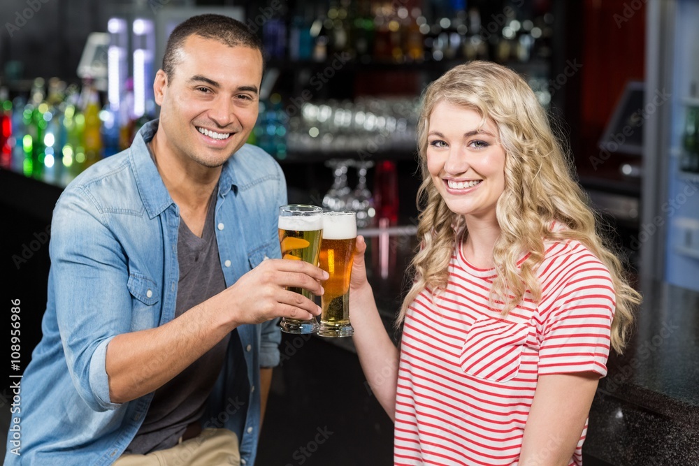 Smiling couple drinking beer