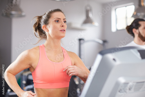 Mature Woman Running On Treadmill In Gym